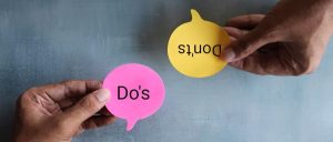 Hands holding Do and Don't signs representing casino marketing strategy decisions