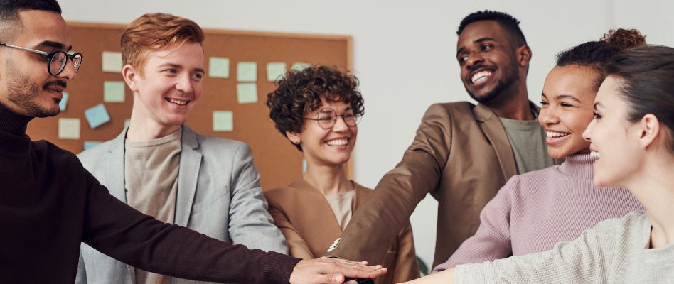 Casino promotions team huddle reviewing a pre-launch checklist and post-promotion film review notes